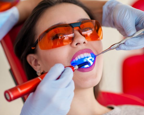 treatment-light-seal-beautiful-girl-dentistry_88340-849